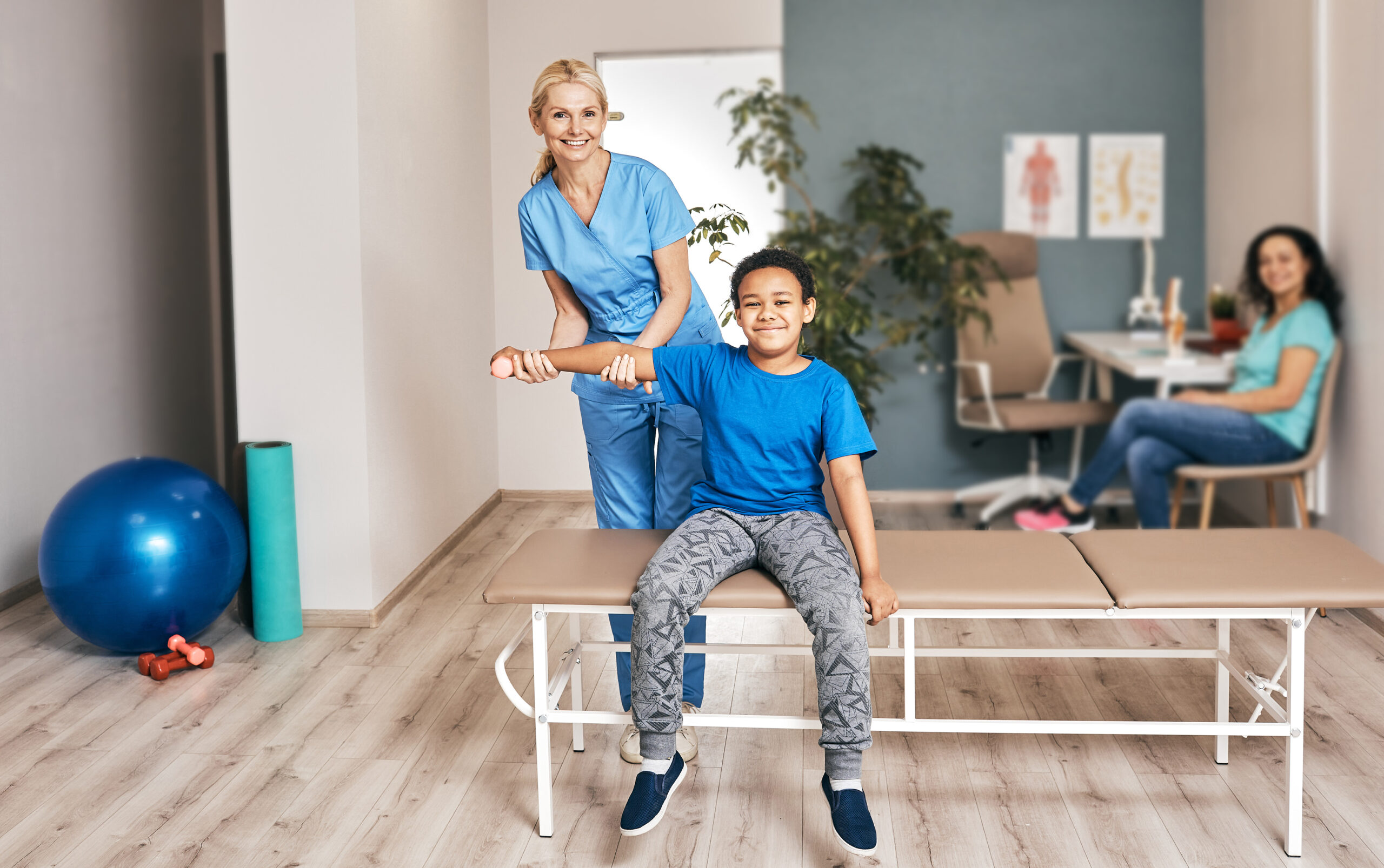 Therapist,Treats,Injured,Hand,Of,African,American,Child,Patient,With